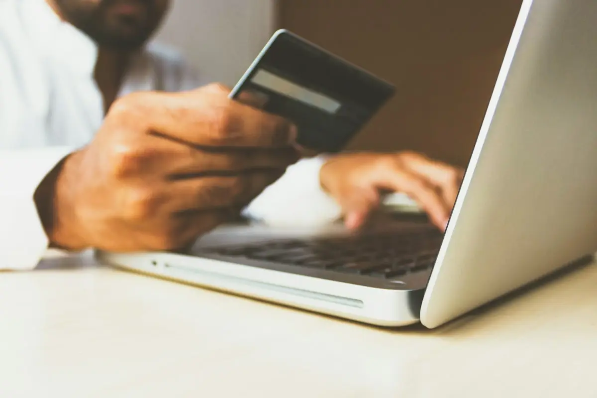 Person entering card details on a laptop at checkout