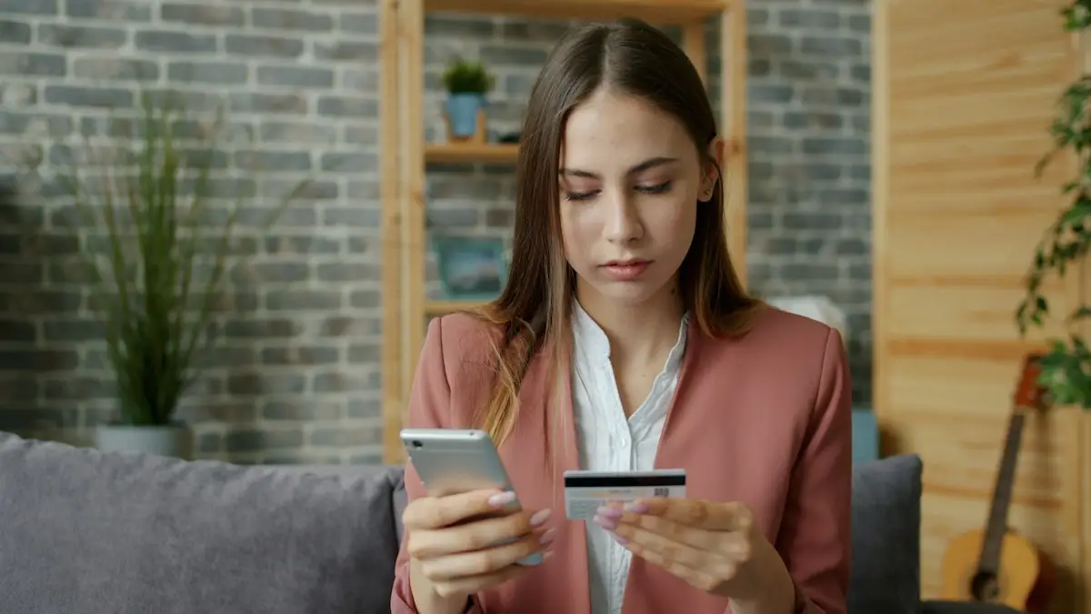 Woman holding a smartphone and payment card