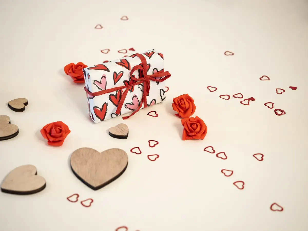 Gift box with hearts and roses on a table
